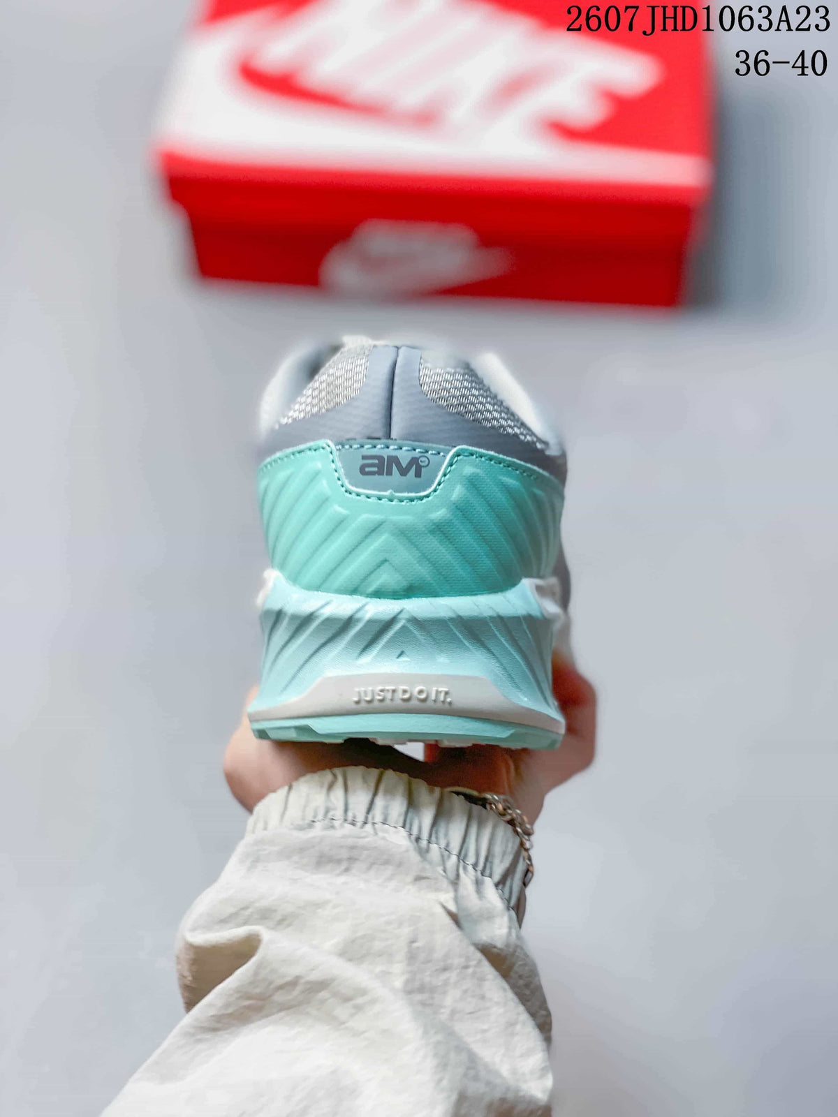 Rear view showing the turquoise heel panel, Air Max branding, and visible heel cushioning details.