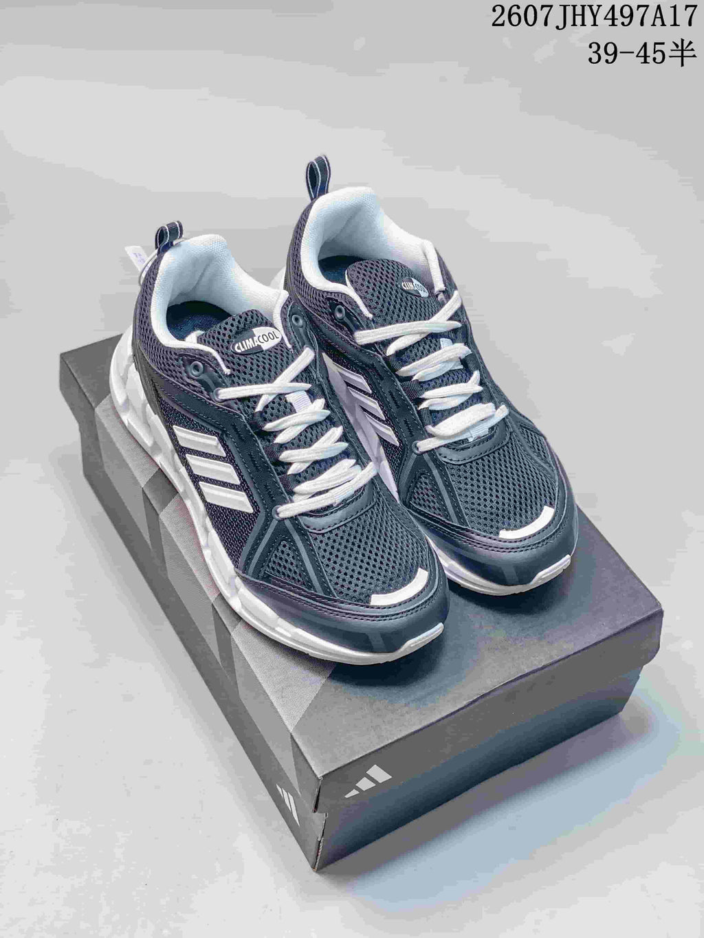 Pair of black and white Adidas Climacool running shoes shown on a shoebox from an elevated front angle.