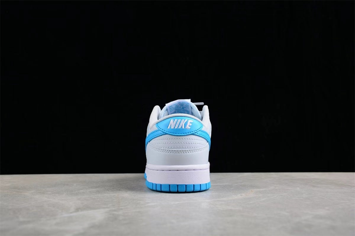 Rear view of the sneaker showing the blue heel detail, white heel panel, padded collar, and blue outsole.