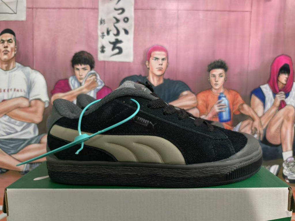 Side view of a black Puma sneaker with taupe side stripes
