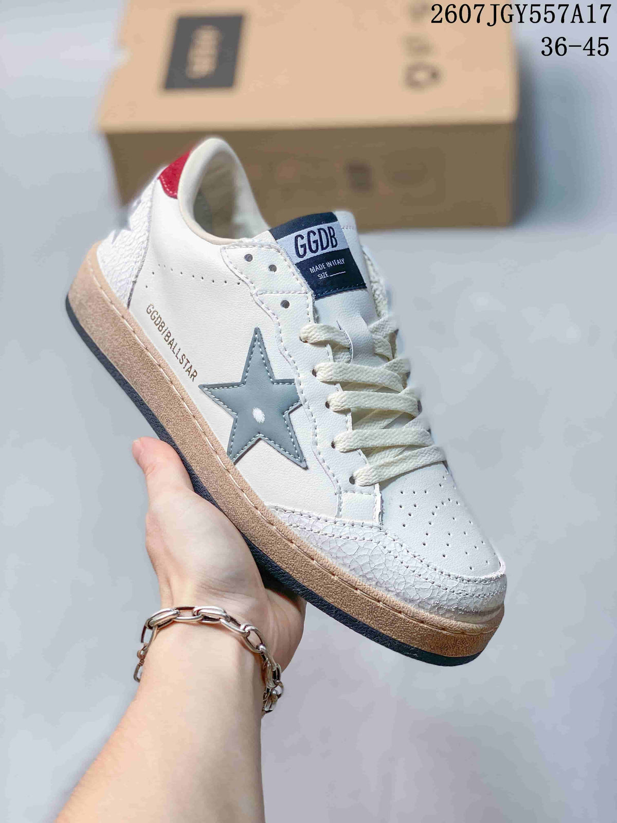 Close-up of a white Golden Goose Ball Star sneaker with a silver-gray star, cream laces, and a dark outsole.