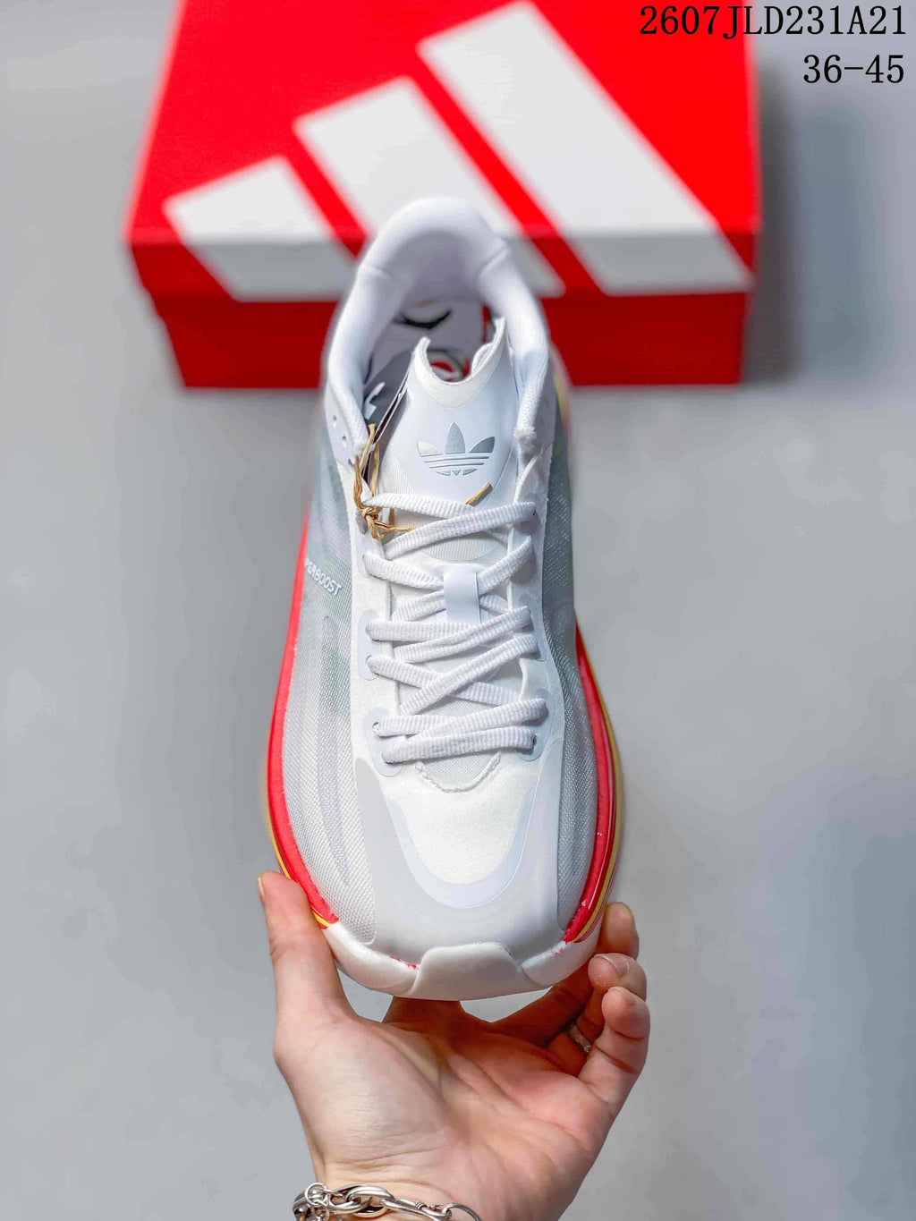 Top view showing the white laces, padded tongue, grey side panels, and trefoil branding.
