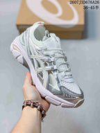 Angled side view of the white and silver ASICS sneaker showing the layered upper, metallic-look overlays, and segmented sole.