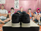 Rear view of black and cream low-top sneakers with Nike Air heel branding