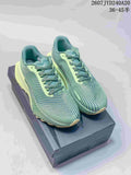 Pair of green and pale lime Nike ACG Ultrafly Trail sneakers displayed on a box; style code and size range text are visible above.