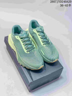 Pair of green and pale lime Nike ACG Ultrafly Trail sneakers displayed on a box; style code and size range text are visible above.