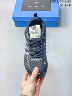 Top view of a charcoal lace-up sneaker with S.F.T.M. tongue branding