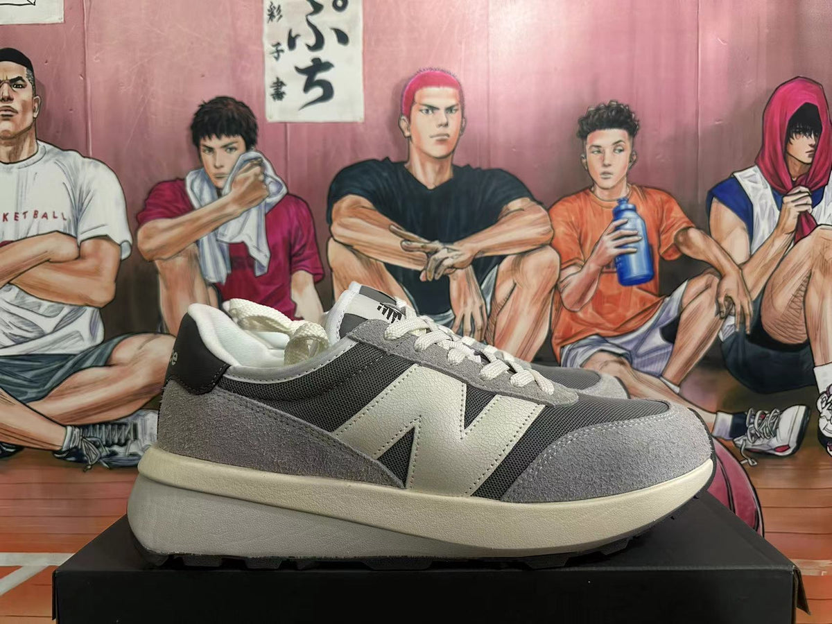 Side profile showing the grey and off-white panels of a New Balance U370 sneaker