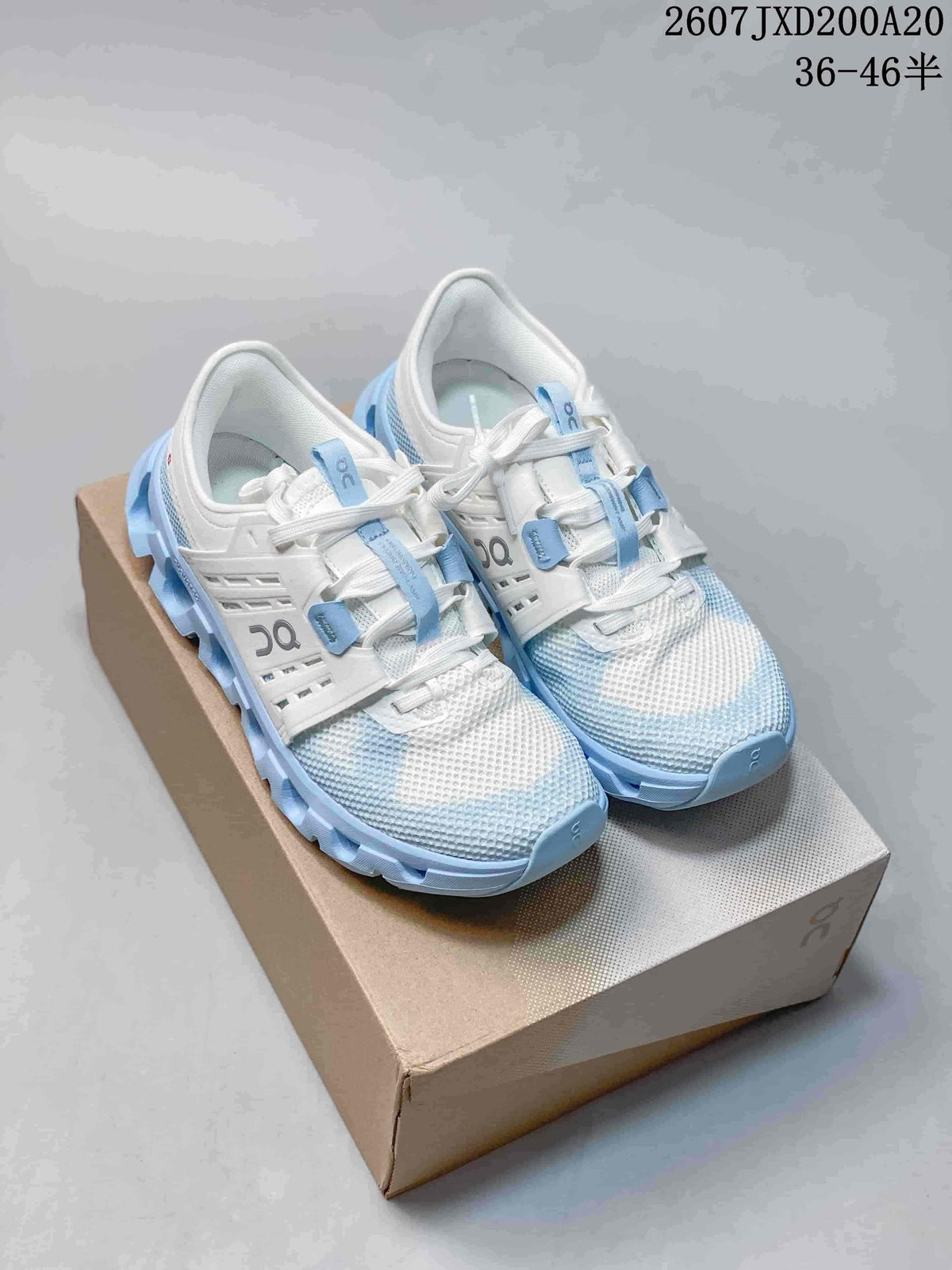 Pair of white and light blue On Cloudswift Amp sneakers displayed on a shoe box.