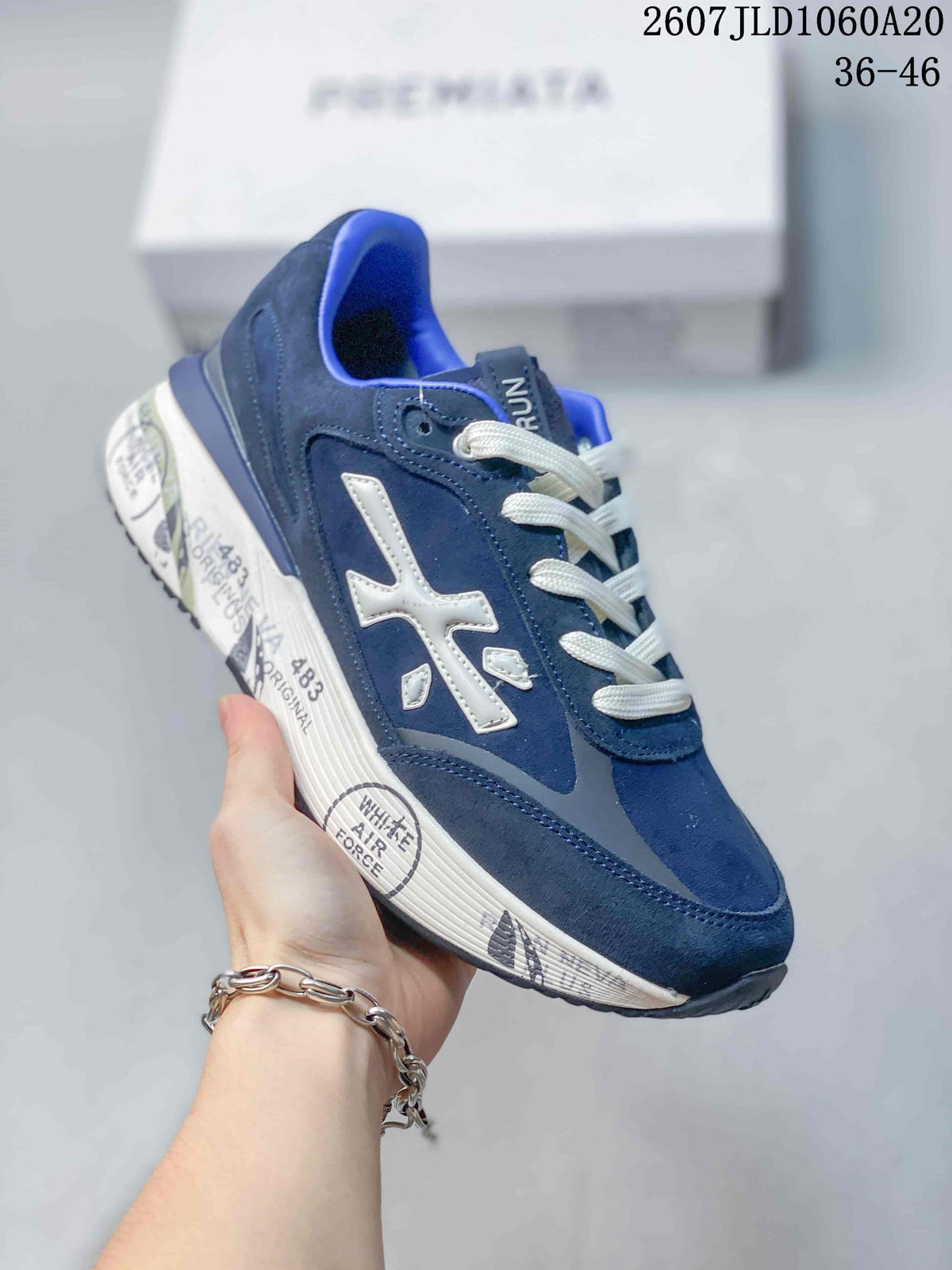 Single navy Premiata Lander trainer showing the side logo, white laces, and printed midsole.