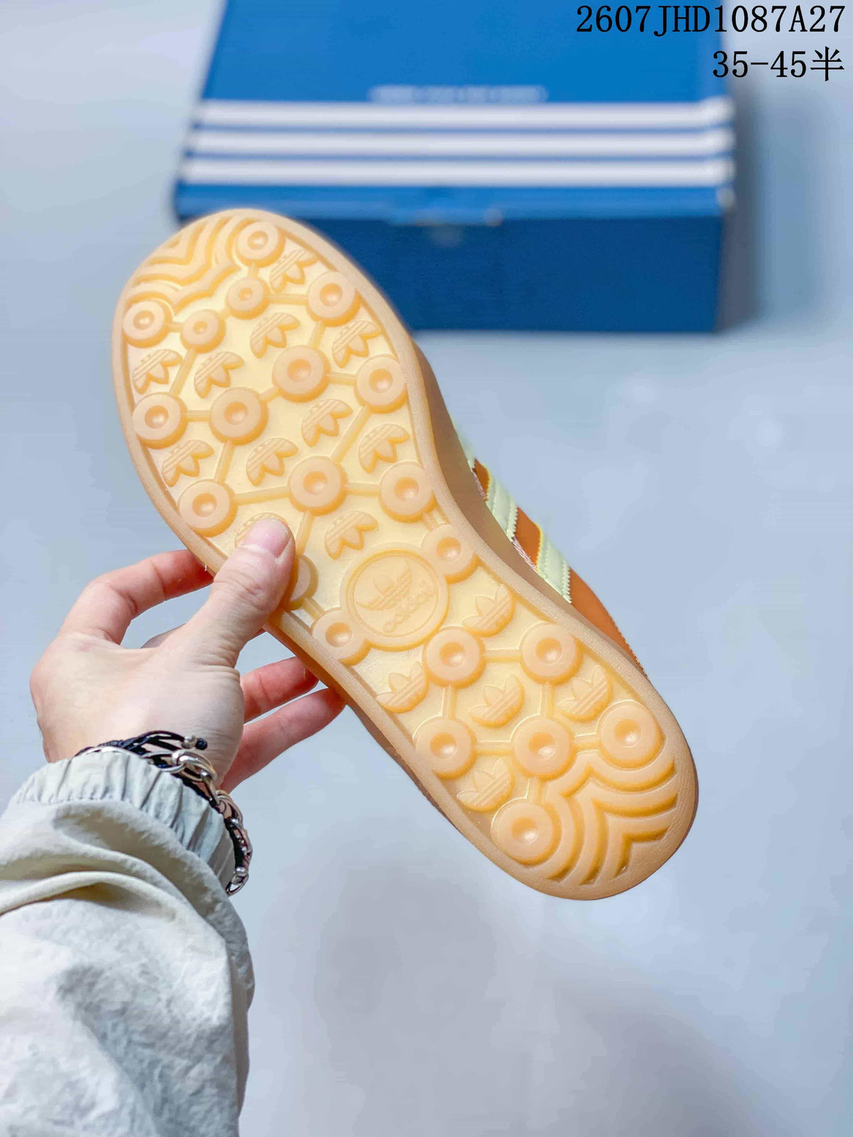 Close view of the gum-colored outsole with circular and trefoil-patterned tread.