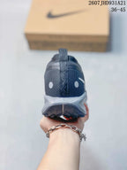 Rear view of the dark gray sneaker showing the heel pull tab, textured upper, and lugged outsole.