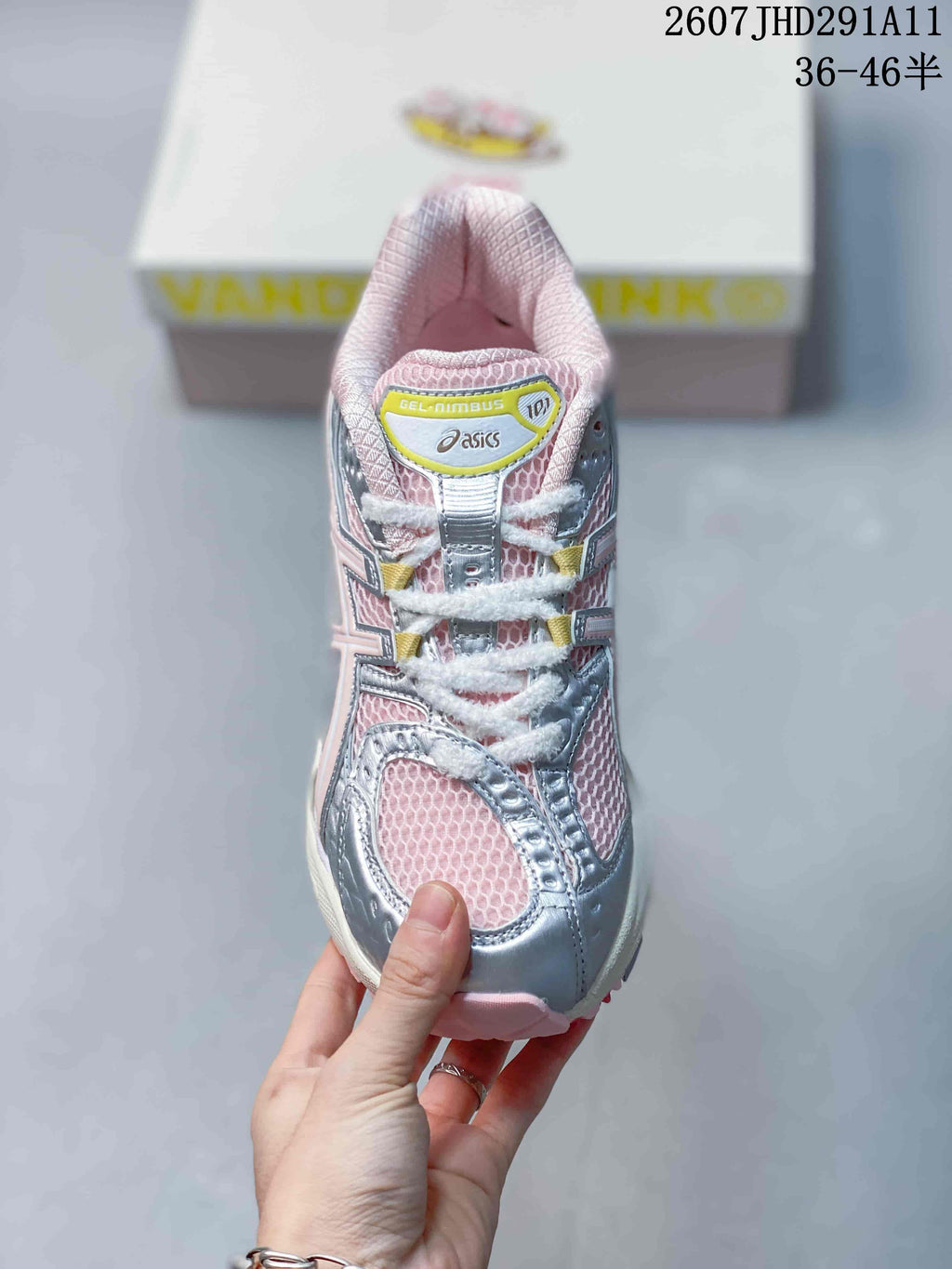 Top view of the sneaker showing the mesh toe box, padded tongue, white laces, and silver-pink color blocking.