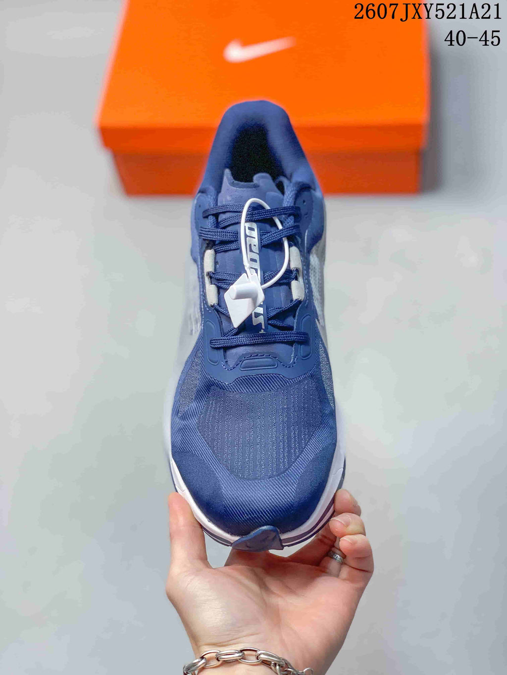 Top view of the navy sneaker showing the lace-up construction, padded tongue, and textured toe box.
