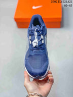 Top view of the navy sneaker showing the lace-up construction, padded tongue, and textured toe box.