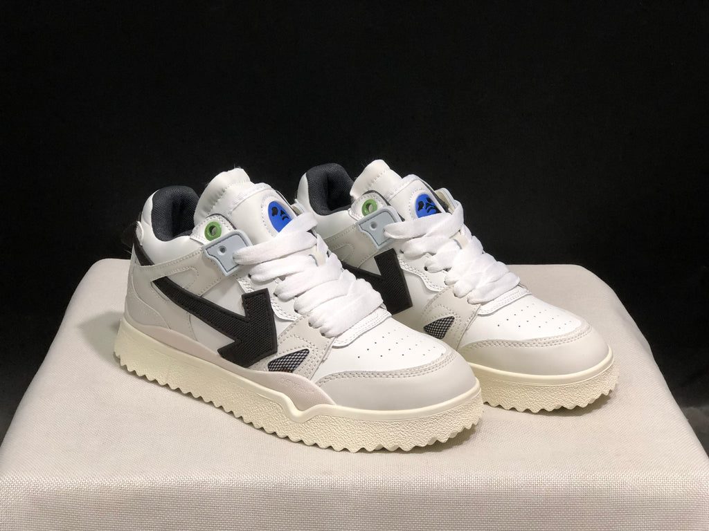 Front three-quarter view of the pair showing white uppers, black side details, and cream-colored soles.