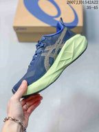 Side profile showing the navy mesh upper, patterned side design, lime midsole and dark outsole.