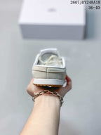 Rear view of the cream mule sneaker showing the open-back styling, heel construction, and white midsole.