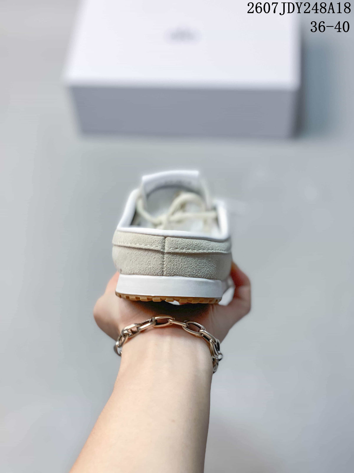 Rear view of the cream mule sneaker showing the open-back styling, heel construction, and white midsole.