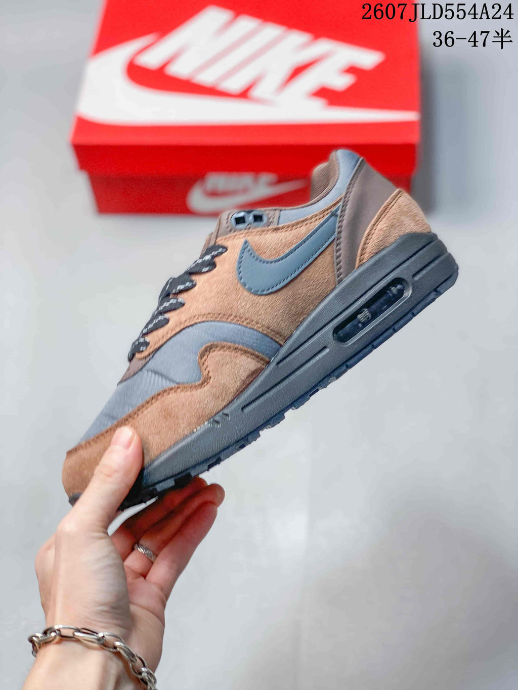Side view of the Nike Air Max 1 sneaker showing the layered upper and visible Air Max window.