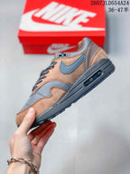 Side view of the Nike Air Max 1 sneaker showing the layered upper and visible Air Max window.