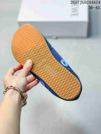 Underside of the sneaker showing a gum-colored outsole with a repeating textured tread pattern and Loewe branding.