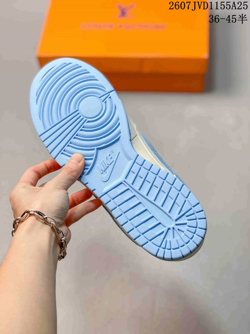 Close view of the light blue outsole with circular and grid traction patterns.
