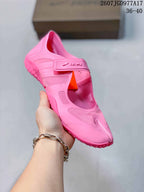 Angled close view of the pink Nike x SKIMS sneaker showing the split-toe front, strap closure and side panels.