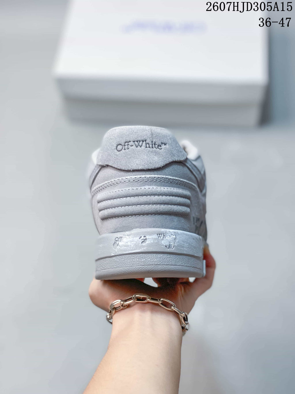 Rear view of the gray sneaker showing the padded heel, layered stitching, and Off-White branding.