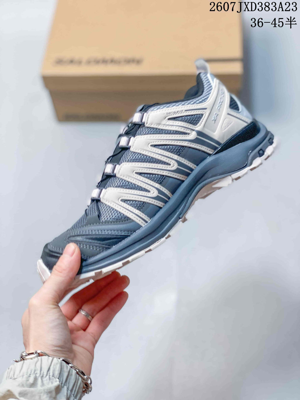 Side profile showing the ash gray mesh-textured upper, contrasting overlays, and low-top construction.