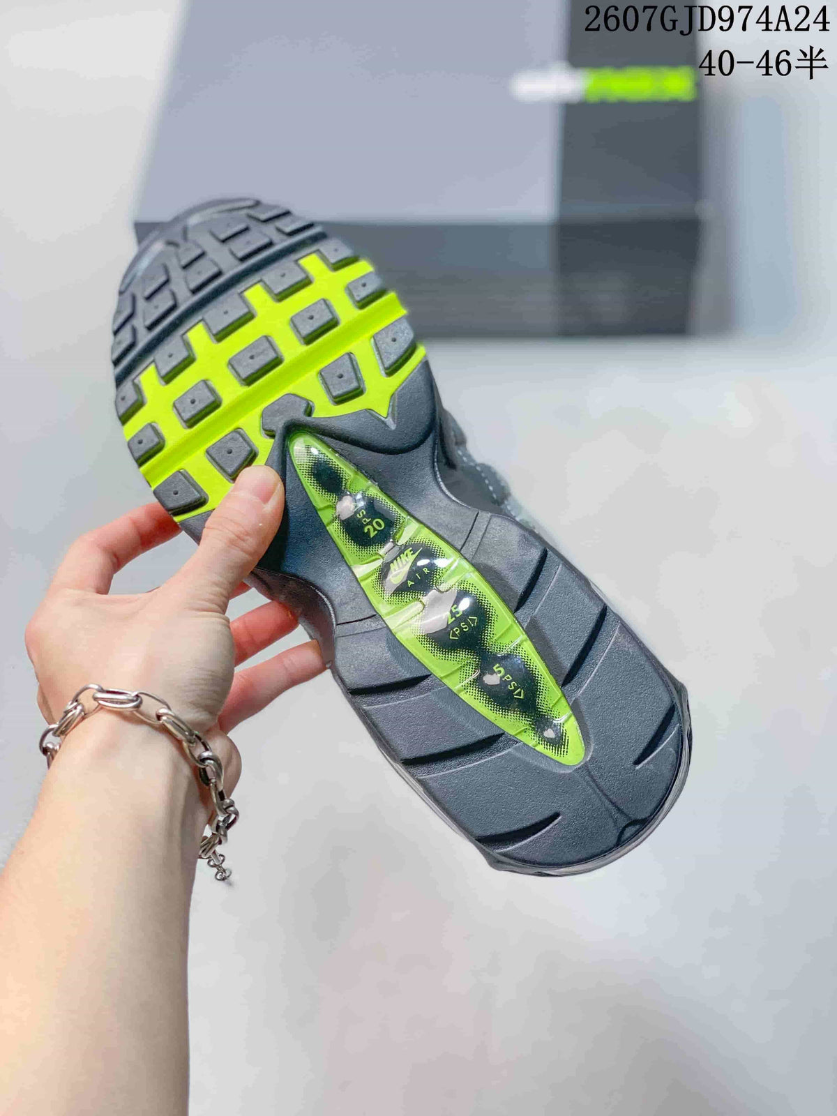 Close view of the sneaker outsole showing black tread, neon green sections and visible air cushioning elements.