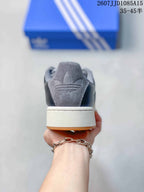 Rear view of the sneaker showing the padded collar, embossed heel detail, white midsole, and gum outsole edge.