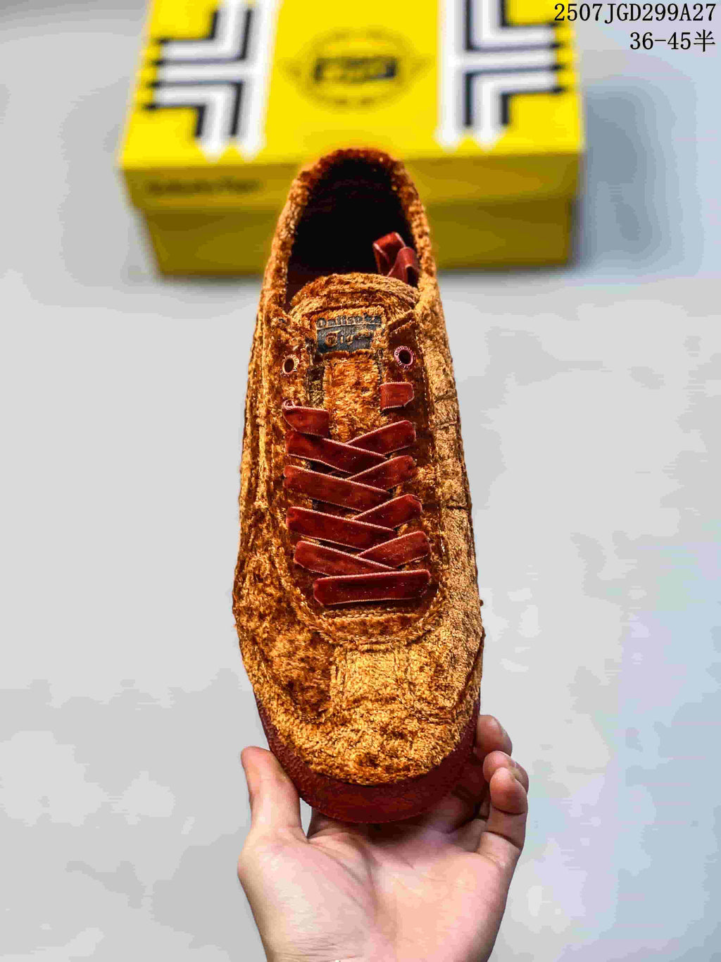 Top view of the brown sneaker showing its rounded toe, dark red laces and tongue branding.