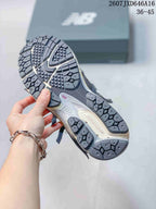 Underside view of a New Balance sneaker showing the segmented patterned outsole.