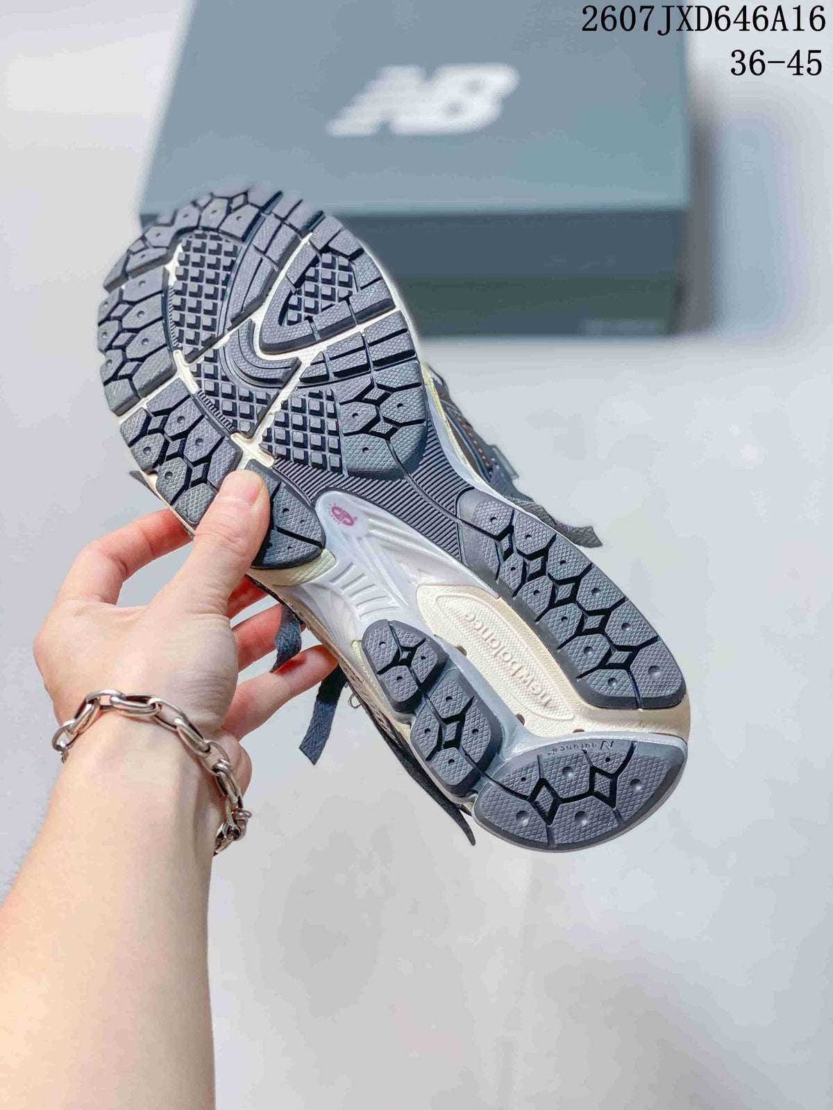 Underside view of a New Balance sneaker showing the segmented patterned outsole.