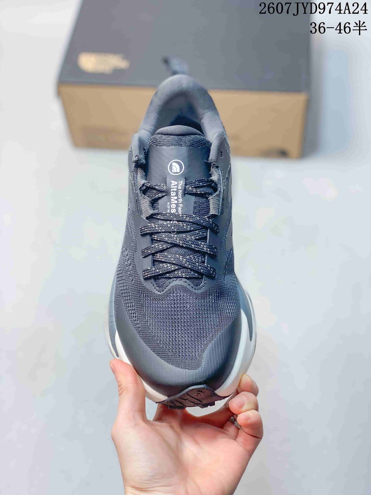 Top view of the sneaker showing the dark gray textured toe box, tongue branding, and lace-up closure.
