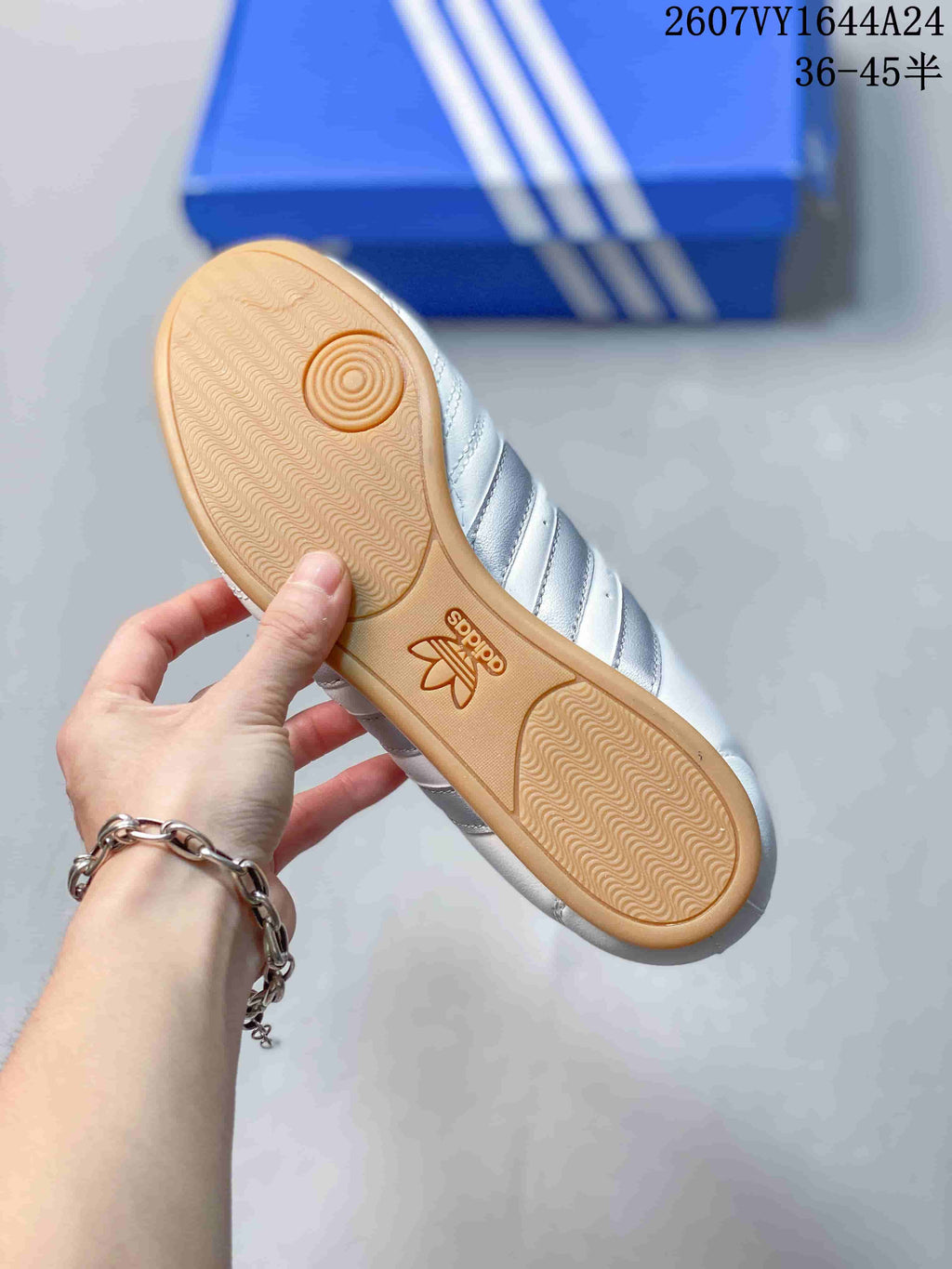 Close-up of the gum-colored outsole showing its textured tread and adidas branding.
