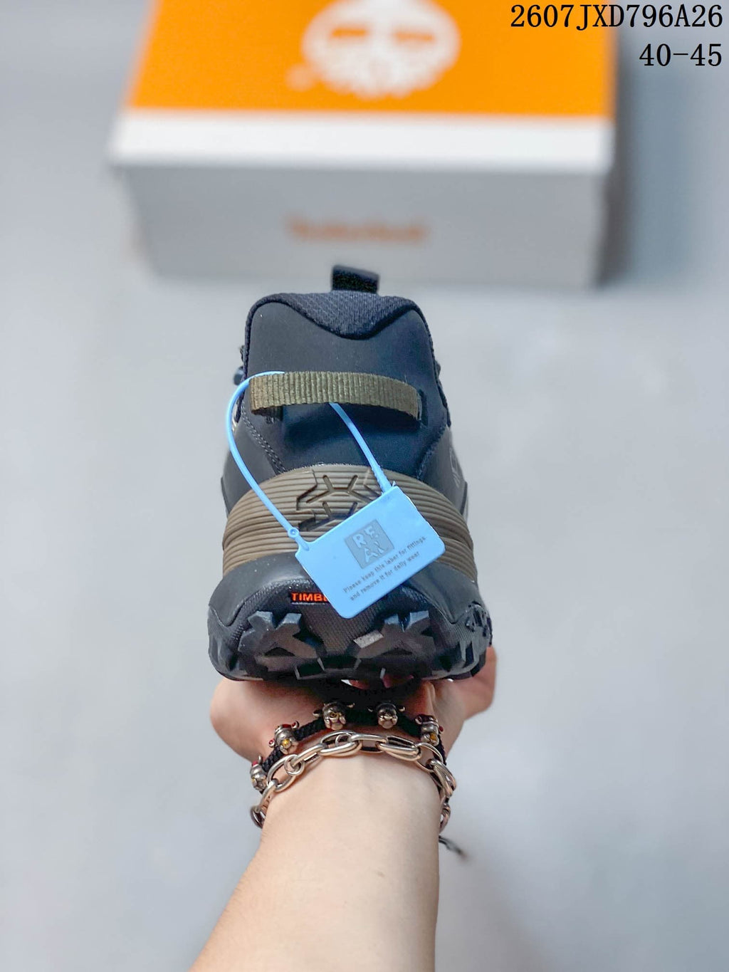 Rear view showing the padded heel collar, heel overlay, and lugged outsole.