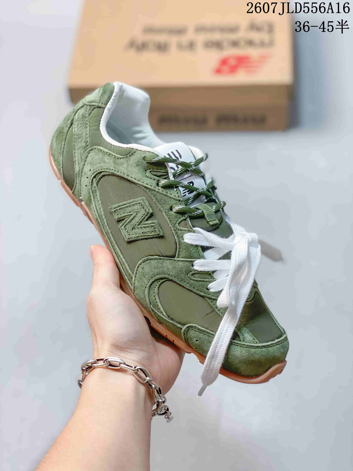 Close-up side view of the green sneaker showing layered panels, New Balance branding, white laces, and a gum-colored outsole.