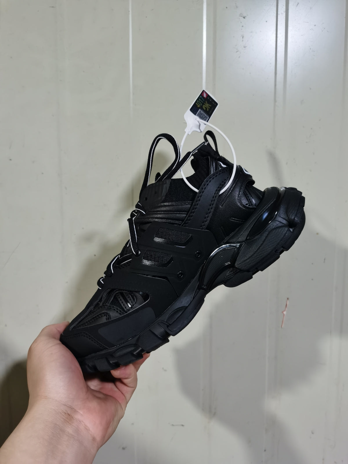 Rear three-quarter view of the black Balenciaga Track Sock sneaker, showing the sock-style collar, layered side structure, and chunky sole.