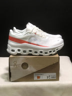 Side view of white Cloudmonster 1 sneakers with a coral-red stripe and sculpted outsole.