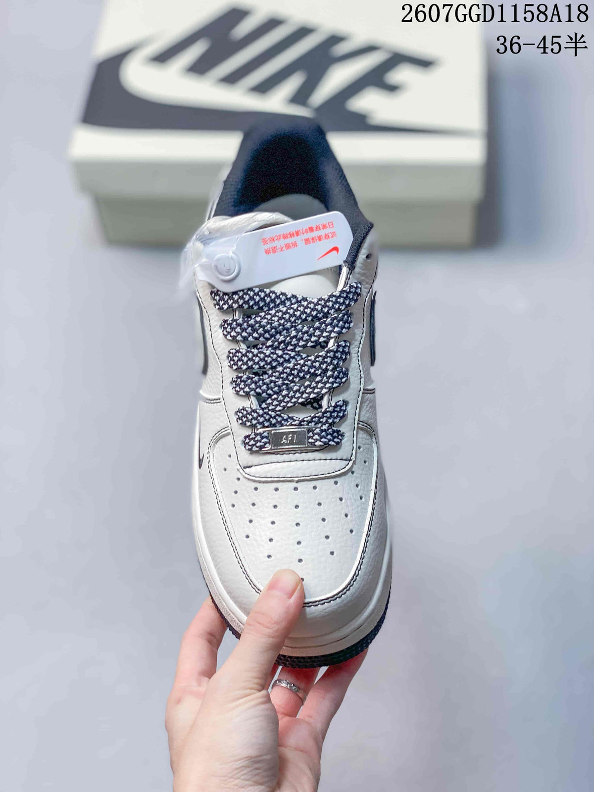 Top view of the white sneaker showing the perforated toe box, patterned laces and tongue branding.