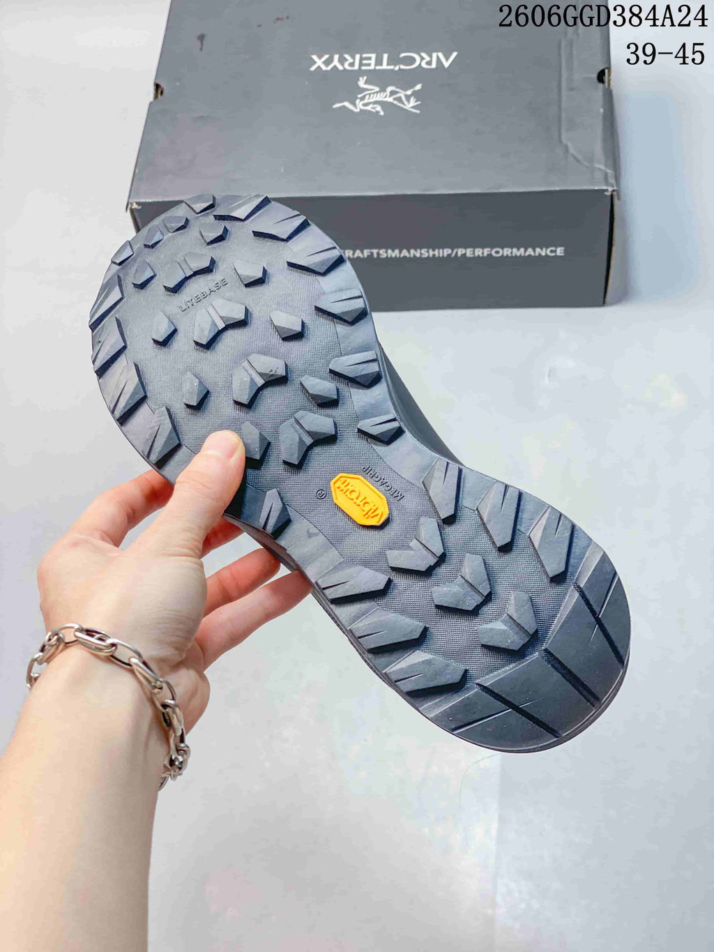 Close-up of the lugged outsole with a Vibram badge