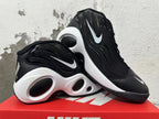 Pair of black sneakers with white Swoosh accents and sculpted white midsoles.