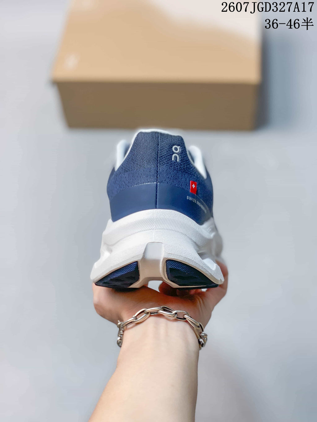 Rear view of the navy sneaker showing the padded heel collar, white midsole, and split outsole design.