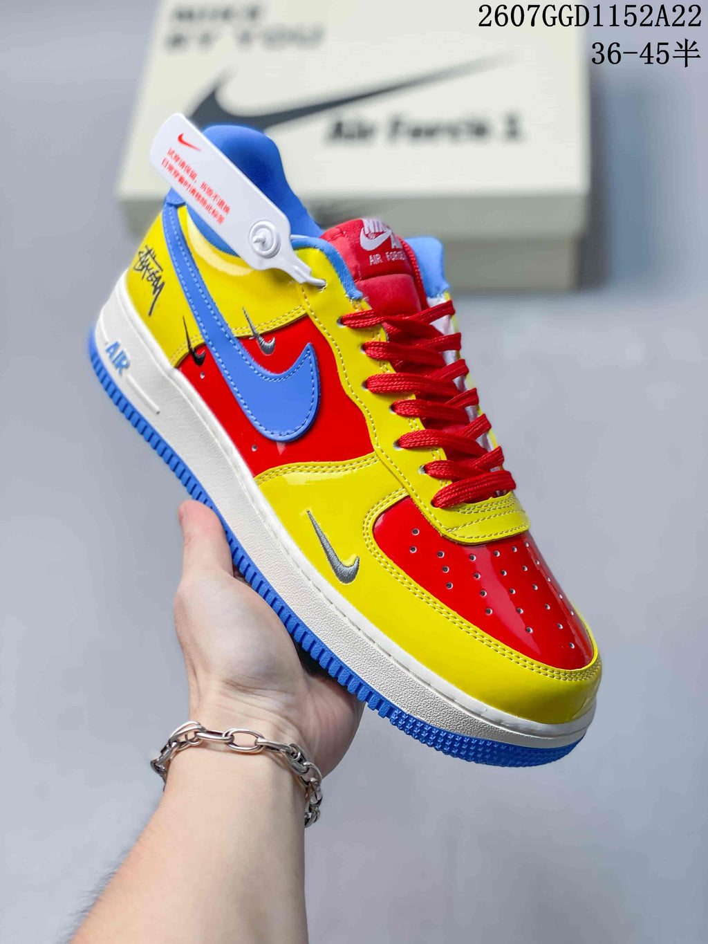 Angled side view of the multicolor Nike Air Force 1 sneaker with red, yellow, and blue panels and a white midsole.
