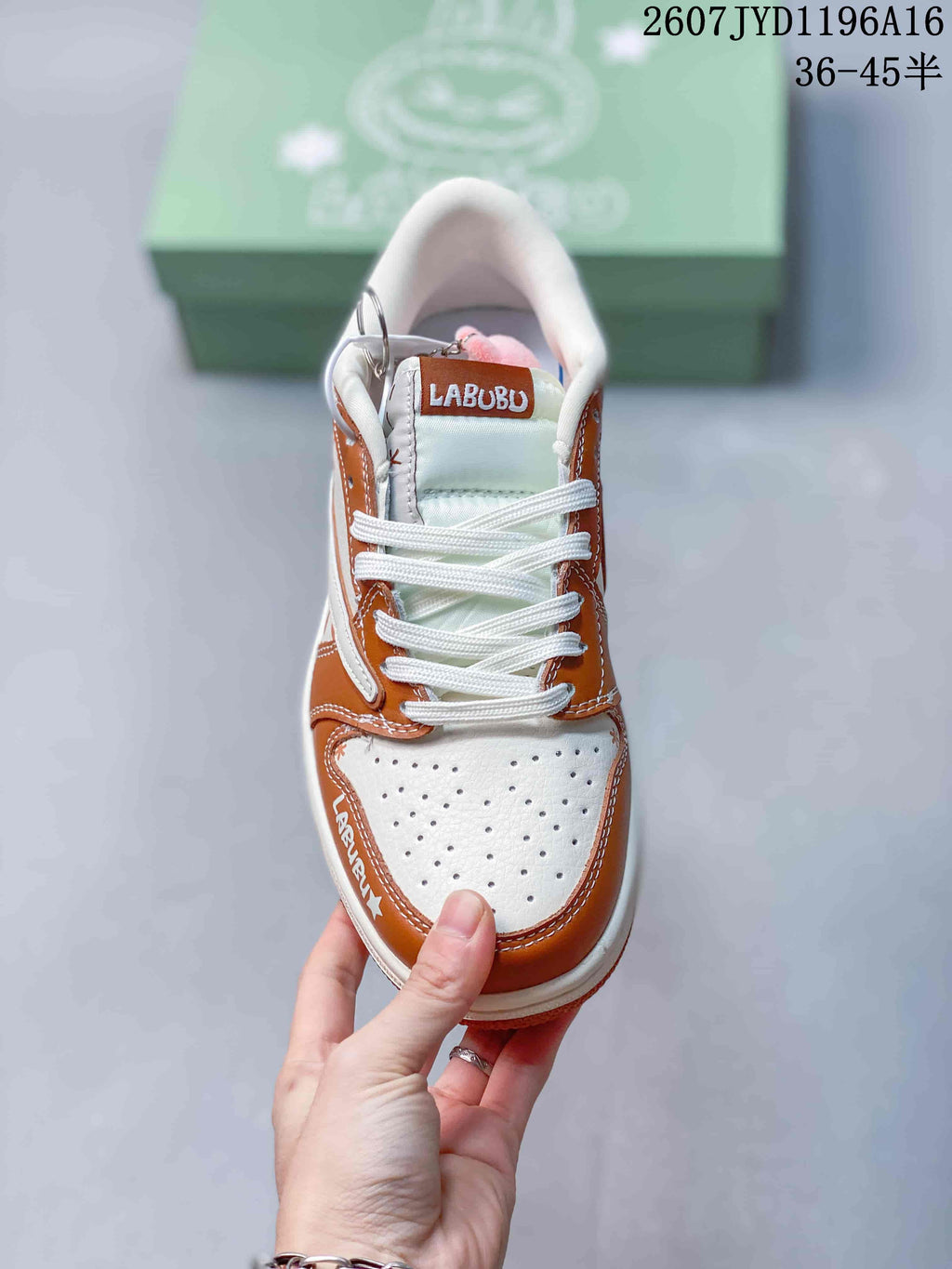 Top view showing white laces, perforated toe panels, brown overlays, and Labubu tongue branding.