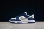 Opposite side profile showing the gray Swoosh, white side panel, navy overlays, and rubber outsole.