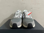 Front view of gray and white New Balance U370 sneakers with white laces.