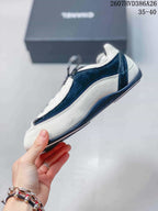 Side profile showing the low-top silhouette, black-and-white color blocking, and layered side panels.